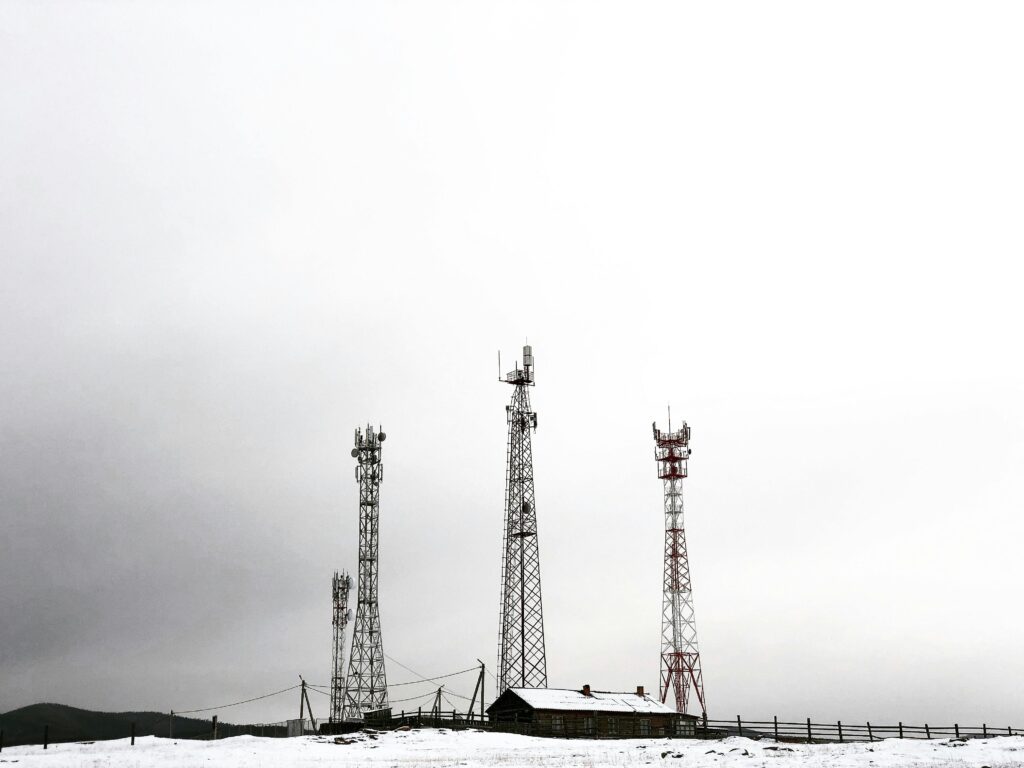 Telecommunication towers in a snowy field in Khuzhir, Russia, highlight technology in winter.
